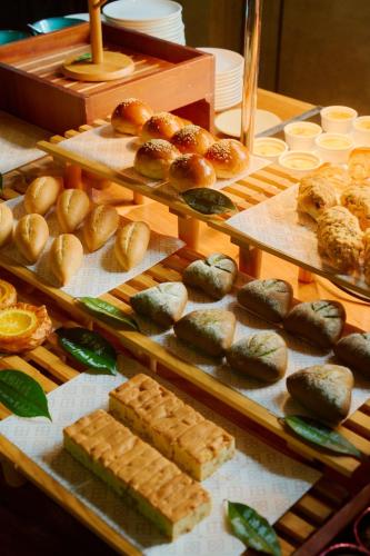 a display case with different types of bread and pastries at Yangshuo Sugar House in Yangshuo