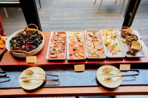 a display case with different types of food on plates at Yangshuo Sugar House in Yangshuo