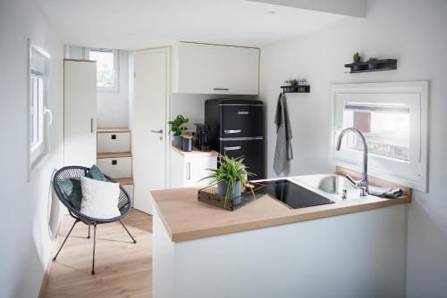 a kitchen with a sink and a counter top at Tiny Om Ferienhaus in Laichingen