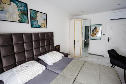 a bedroom with a large bed and a mirror at SD Hotel in Georgsmarienhütte