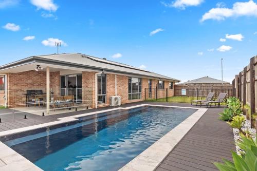 a swimming pool in the backyard of a house at 'The Pool House' Spacious Family Stay at Hervey Bay in Hervey Bay