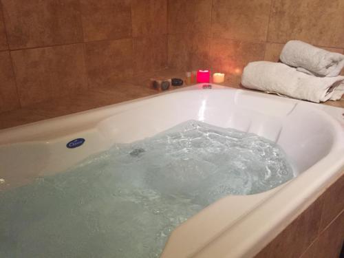 a bath tub filled with water in a bathroom at LaTorre Aparts in El Calafate