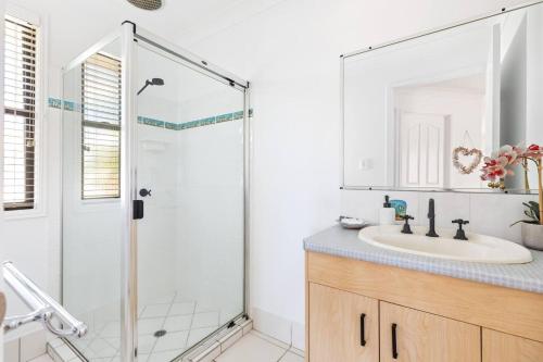 a bathroom with a shower and a sink at Discover Coastal Living Perfection at Point Vernon in Hervey Bay