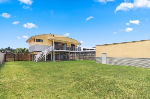a building with a large yard in front of it at Discover Coastal Living Perfection at Point Vernon in Hervey Bay