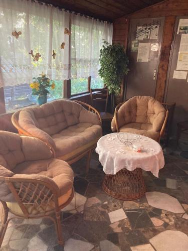 a living room with two chairs and a table at Rekreační chata Hradištko in Hradištko