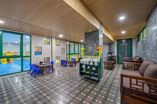 a room with a lobby with a pool and furniture at La Siesta Hoi An Resort & Spa in Hoi An