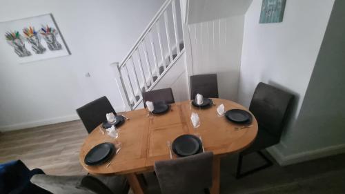 a wooden table in a room with chairs around it at Eyre Square Lane Budget Rooms in Galway