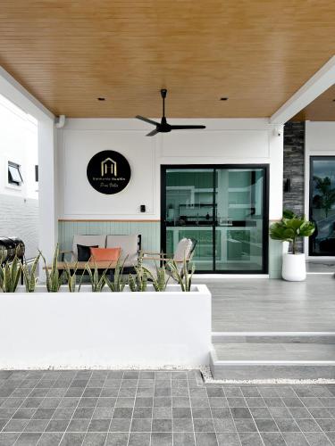 a patio with chairs and a ceiling at Harmonic HuaHin Pool Villa-3BR, 3 Bath, 2 Kitchen in Hua Hin