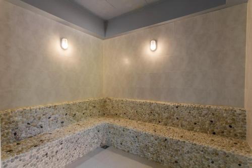 a bathroom with a tub with two lights on the wall at В7 НОВАЯ КВАРТИРА ВАТСАП669З582I976 можно РУБЛЯМИ in Nai Yang Beach