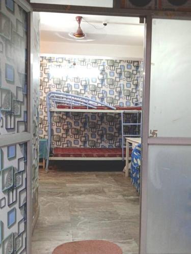 a room with a room with a wall covered in tiles at Venus Homestay in Kolkata