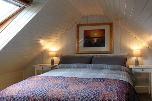 a bedroom with a bed in a attic at Smithy Cottage in Strathdon