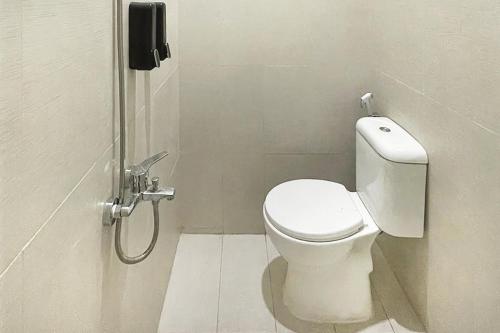 a bathroom with a toilet and a shower stall at Urbanview Syariah Don Juan Pondok Gede in Warungsergon