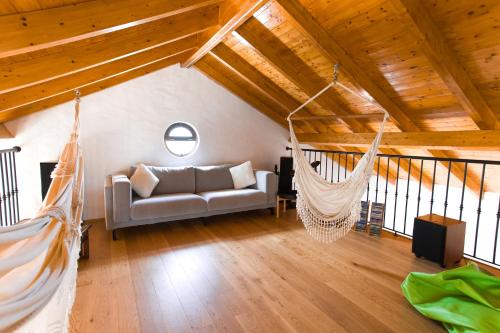 a living room with a couch and hammocks in a attic at Villa Casa Velha in Portimão