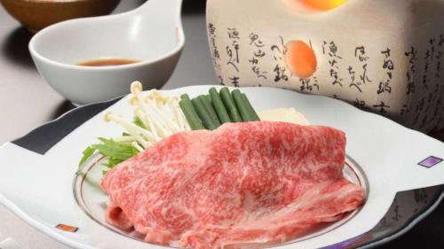 a plate of meat and vegetables and a bowl of soup at Sannouzan Onsen Zuisenkyo in Ichinoseki