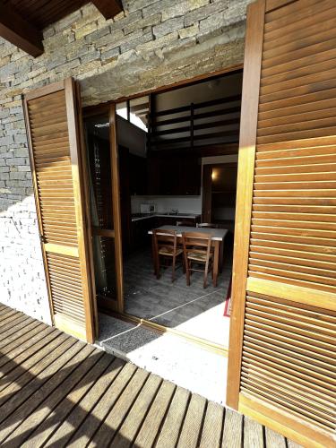 a glass door leading to a patio with a table at Chalet Edelweiss - Estella Hotel Collection in Sestriere