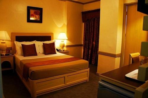 Ένα ή περισσότερα κρεβάτια σε δωμάτιο στο PHELA GRANDE HOTEL