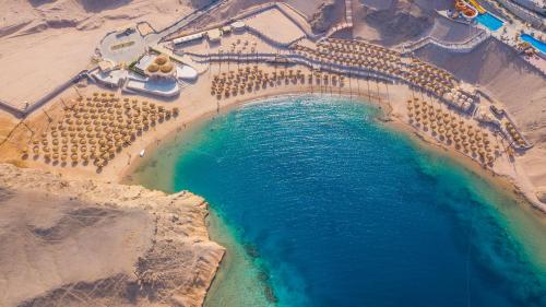 an aerial view of a beach with a pool of water at Siva Golden Bay Makadi in Hurghada