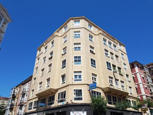 a tall white building on a city street at Hospedaje Magallanes in Santander