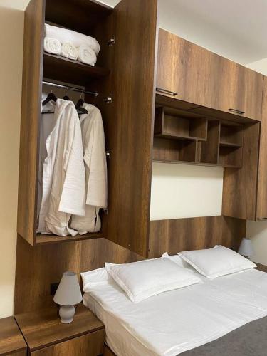 a bedroom with a bed and a closet with towels at Tbilisi cozy appartment in Tbilisi City