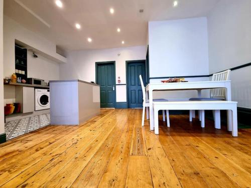 a kitchen with a white table and chairs in a room at Central Location with Garden in Seaford