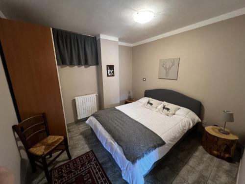 a bedroom with a bed and a chair at Chalet Edelweiss - Estella Hotel Collection in Sestriere