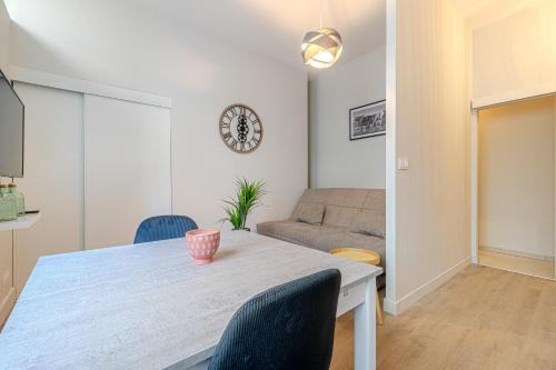 une salle à manger avec une table et un canapé dans l'établissement Le léger 1900, à Limoges
