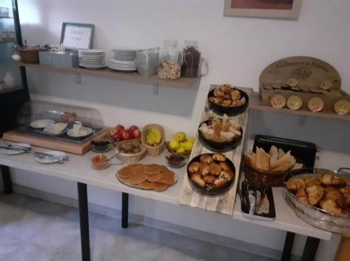 a table filled with lots of different types of food at Hôtel Les Alizés in Puget-Théniers