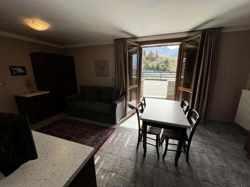 a living room with a table and a couch at Chalet Edelweiss - Estella Hotel Collection in Sestriere