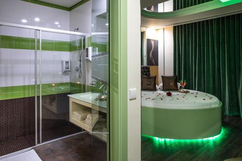 a bathroom with a shower and a tub with a sink at Motel Emoções in Nogueira da Regedoura