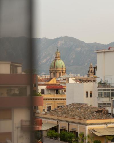a view of a city with mountains in the background at Mercure Palermo Centro in Palermo