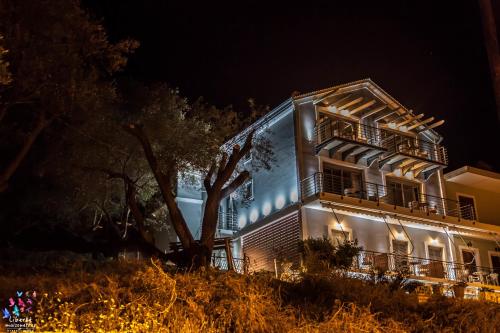 a building with lights on it at night at Liberte Maisonettes in Parga