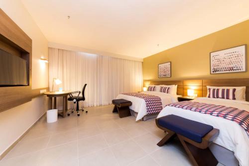 En eller flere senge i et værelse på Tulip Inn Campos dos Goytacazes