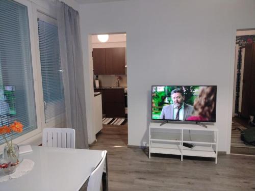 a living room with a flat screen tv on a stand at Ihastuttava kaksio Lahdessa in Lahti