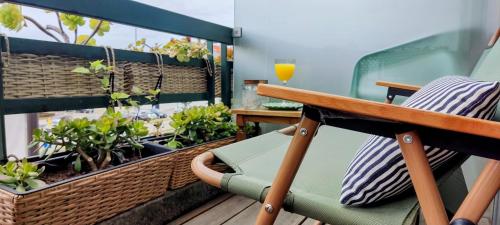 a balcony with a table and chairs and plants at IH Apartments & Studios in Espinho