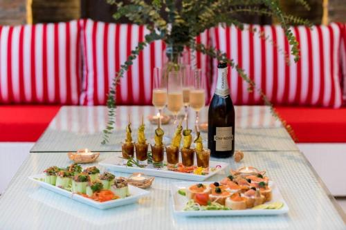 a table with two plates of food and a bottle of wine at Villa Mango with staff (brand new) in Amphoe Koh Samui