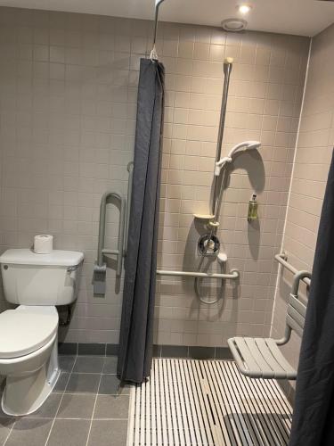 a bathroom with a toilet and a shower stall at Canterbury Cathedral Lodge in Canterbury