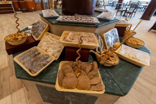 a counter with several baskets of food on a table at Siva Golden Bay Makadi in Hurghada