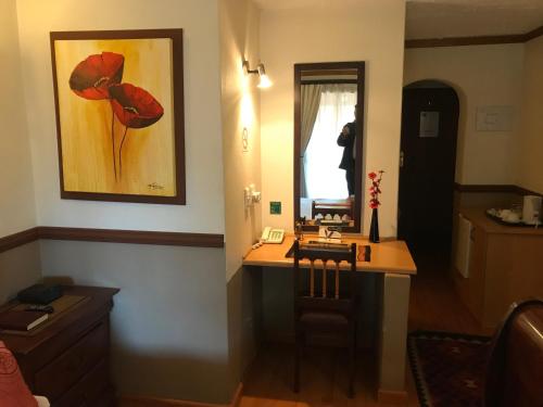 a room with a desk and a painting of a poppy at De Oude Herberg in Centurion