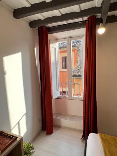 a room with a window and a red curtain at Charming Navona in Rome