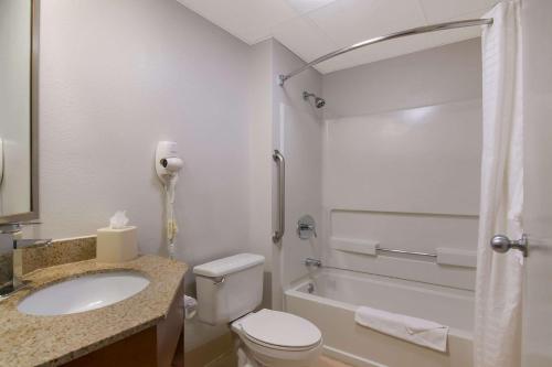 a bathroom with a toilet and a sink and a tub at Quality Inn Mystic-Groton in Mystic