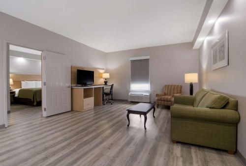 a living room with a couch and a bed at Quality Inn Goldsboro in Goldsboro