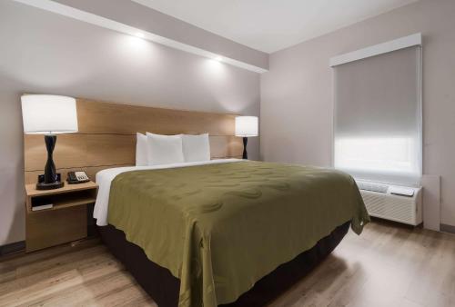 a hotel room with a bed and a window at Quality Inn Goldsboro in Goldsboro