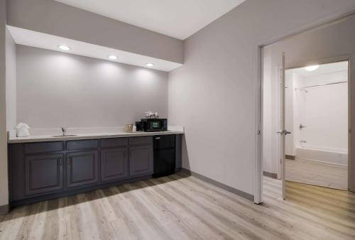 an empty kitchen with a sink and a counter at Quality Inn near Seymour Johnson AFB in Goldsboro