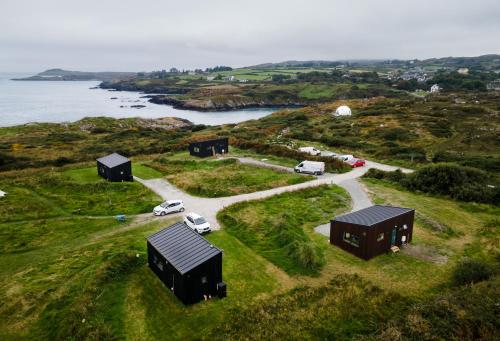 an aerial view of a house on a hill next to the ocean at Goleen Harbour in Goleen