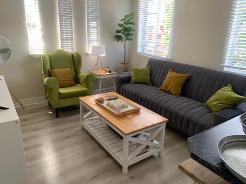 a living room with a couch and two chairs at The Lazy Expat in Paarl