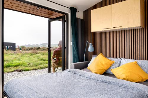 a bedroom with a bed and a sliding glass door at Goleen Harbour in Goleen