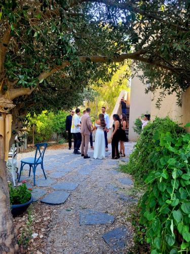 a bride and groom walking down a path at their wedding at צימר חלון לרקפות zimer Window for primroses עם ג'קוזי לנוף in Tal Shaẖar