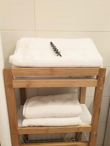 a towel shelf with towels and a comb on top at Apartmán CENTRAL, near the center, self check in 24 h, free parking in Banská Bystrica