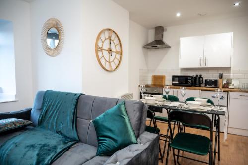 a living room with a couch and a table at Bv Charming 2-Bedroom Apartment by Kirkstall Shopping Centre, Free Parking in Leeds