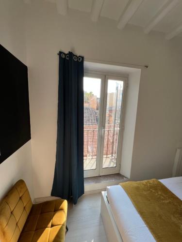 a bedroom with a bed and a large window at Charming Navona in Rome